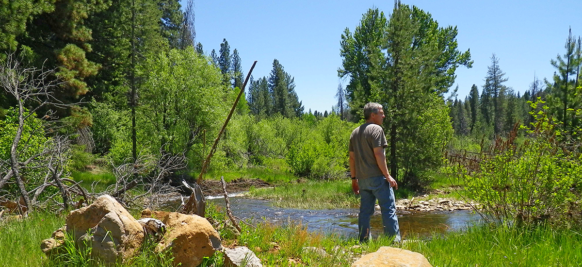 man by river.1200x550